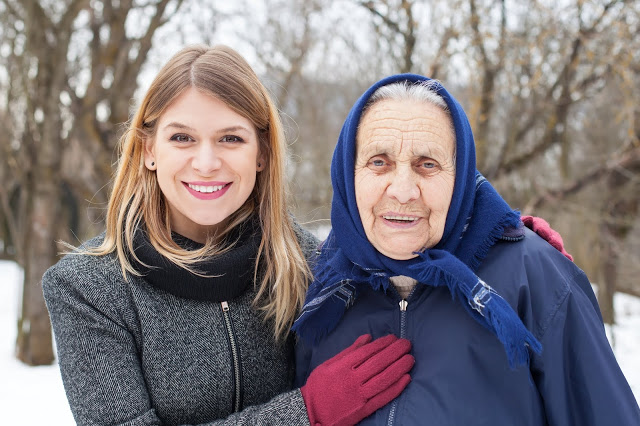 Picture of a cute elderly woman with her helping caretaker